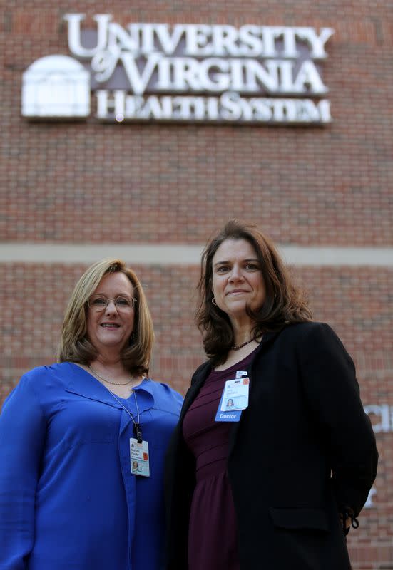 Dr. Mendy Poulter and Dr. Amy Mathers stand outside the University of Virginia Medical Center in Charlottesville, Virginia