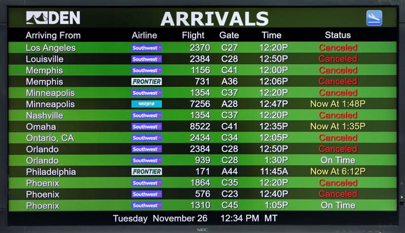 The arrivals board shows cancelled flights after a snowstorm at Denver International Airport