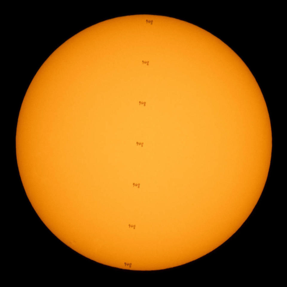 This composite image made from seven frames shows the International Space Station, with a crew of seven onboard, in silhouette as it transits the sun on Friday, June 25, 2021, from near Nellysford, Va.  / Credit: NASA/Joel Kowsky