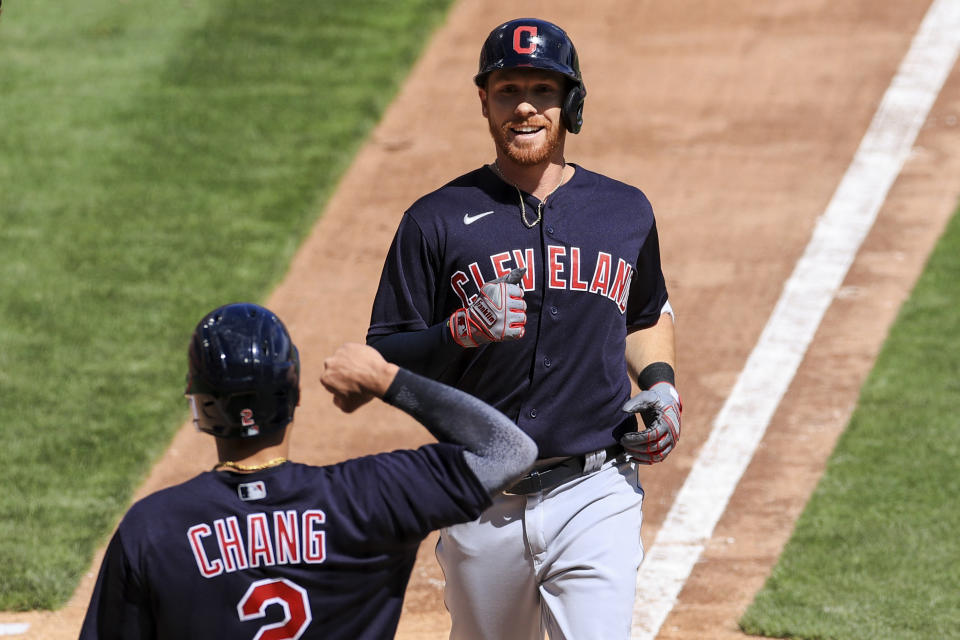 Cleveland Indians' Jordan Luplow reacts with teammate Yu Chang after hitting a two-run home run during the seventh inning of a baseball game against the Cincinnati Reds in Cincinnati, Sunday, April 18, 2021. (AP Photo/Aaron Doster)