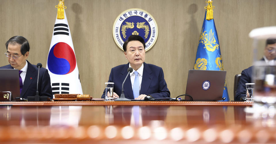 South Korean President Yoon Suk Yeol, center, speaks during a Cabinet Council meeting at the presidential office in Seoul, South Korea, Tuesday, Dec. 19, 2023. Yoon said during the meeting on Tuesday that a “nuclear-based, powerful Korea-U.S. alliance” would be formed soon. The president's announcement came after North Korea's state media reported Tuesday that it has tested what it says is an intercontinental ballistic missile launch. (Yonhap via AP)