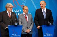 Brandenburg's Prime Minister Dietmar Woidke, state Minister for Economy and Energy Joerg Steinbach and head of the district Oder-Spree authority Rolf Lindemann address media on Tesla European factory in Potsdam