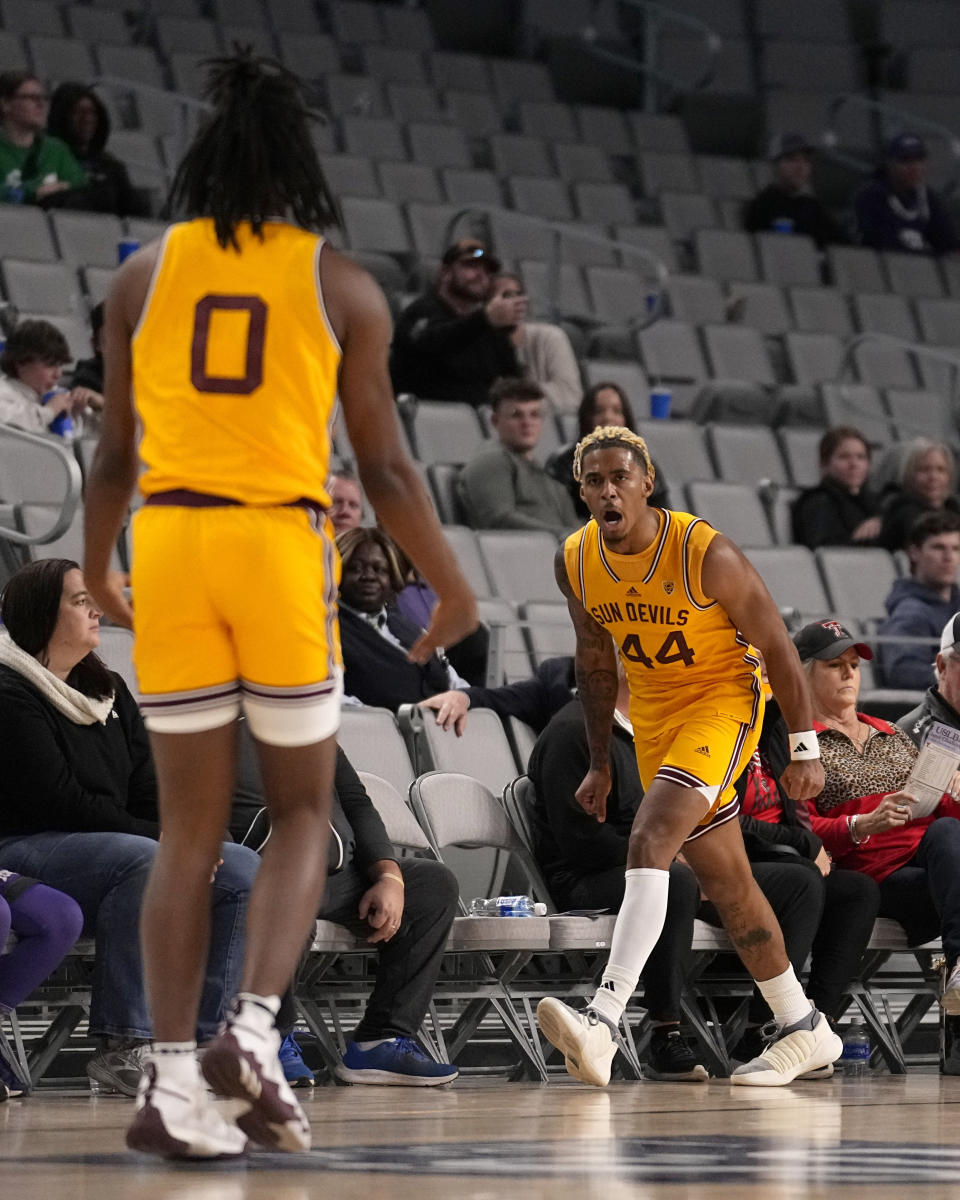 Arizona State guard Adam Miller (44) celebrates his 3-point basket against TCU with Kamari Lands (0) during the first half of an NCAA college basketball game in Fort Worth, Texas, Saturday, Dec. 16, 2023. (AP Photo/Tony Gutierrez)