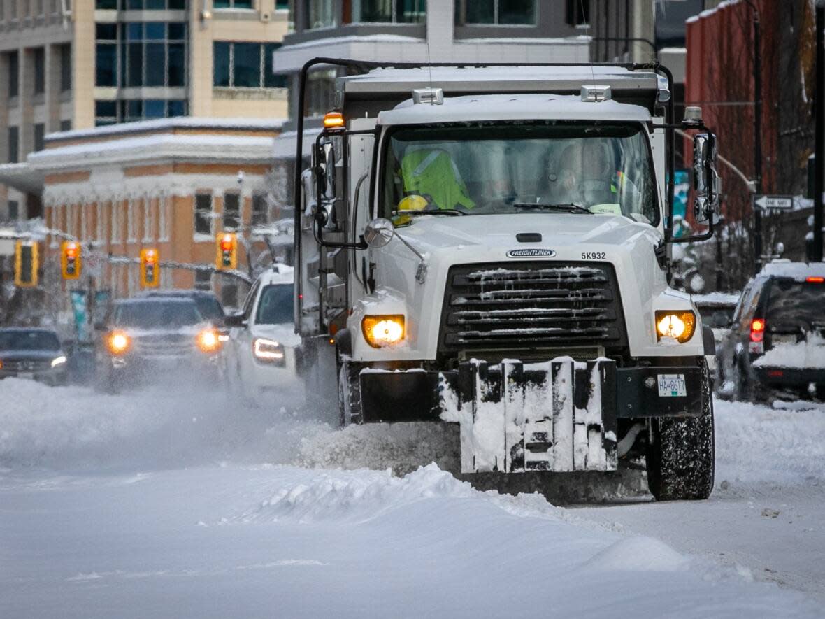 Snow is plowed on Douglas Street in Victoria, B.C., after 30 centimetres of snow fell overnight. (Mike McArthur/CBC - image credit)