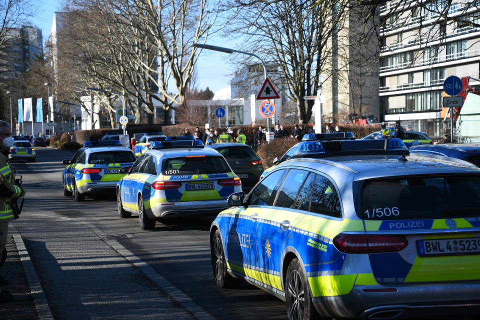 Police vehicles are parked on the grounds of Heidelberg University in Heidelberg, Germany, Monday, Jan. 24, 2022. German police say a lone gunman wounded several people at a lecture theatre in the southwest city of Heidelberg on Monday. Police said in a brief statement that the perpetrator was dead but didn’t give details of how that happened. (R.Priebe/Pr-Video/dpa via AP)