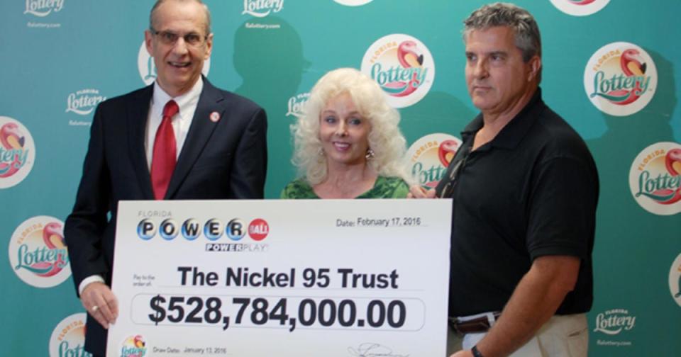Maureen Smith, middle, and David Kaltschmidt, right, claimed their share of the $1.6 billion Powerball jackpot in 2016. The couple opted to take the lump sum payment of about $327.8 million.