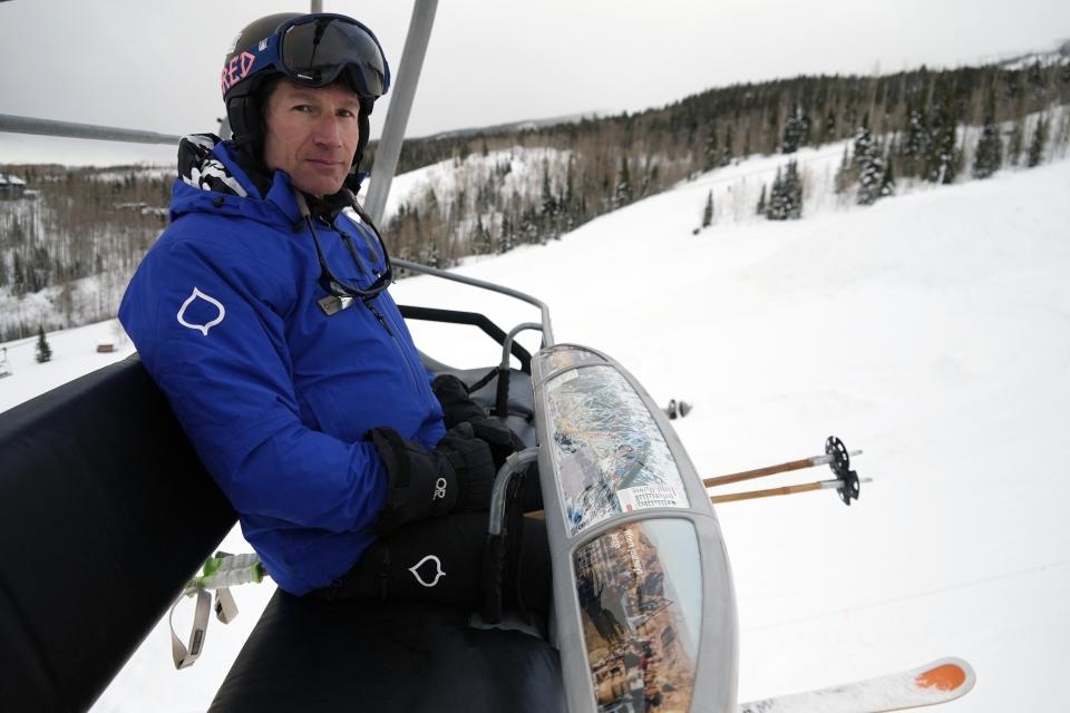 Auden Schendler, Aspen Skiing Company's vice-president of sustainability, rides a ski lift at Snomass ski mountain on Monday, Jan. 9, 2023, in Snowmass, Colo. (AP Photo/Brittany Peterson)