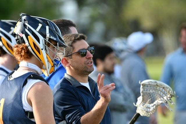 Ramsey boys lacrosse coach Dan DeMartino chats with defender Justus Favata during a preseason scrimmage in Florida.