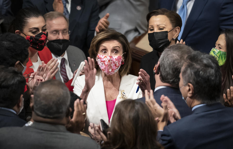 Speaker of the House Nancy Pelosi, D-Calif., celebrates in the chamber with her caucus after the House approved the Democrats' sweeping social and environment bill, giving a victory to President Joe Biden, at the Capitol in Washington, Friday, Nov. 19, 2021. (AP Photo/J. Scott Applewhite)