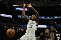 Milwaukee Bucks' Khris Middleton is fouled by Miami Heat's Kyle Lowry during the second half of an NBA basketball game Saturday, Dec. 4, 2021, in Milwaukee. (AP Photo/Morry Gash)