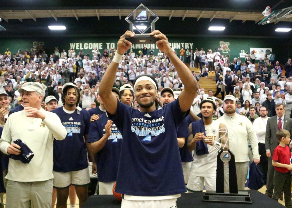 Vermont's Dylan Penn hoists his Most Oustanding Player award in front of the crowd at Patrick Gym on Saturday afternoon.