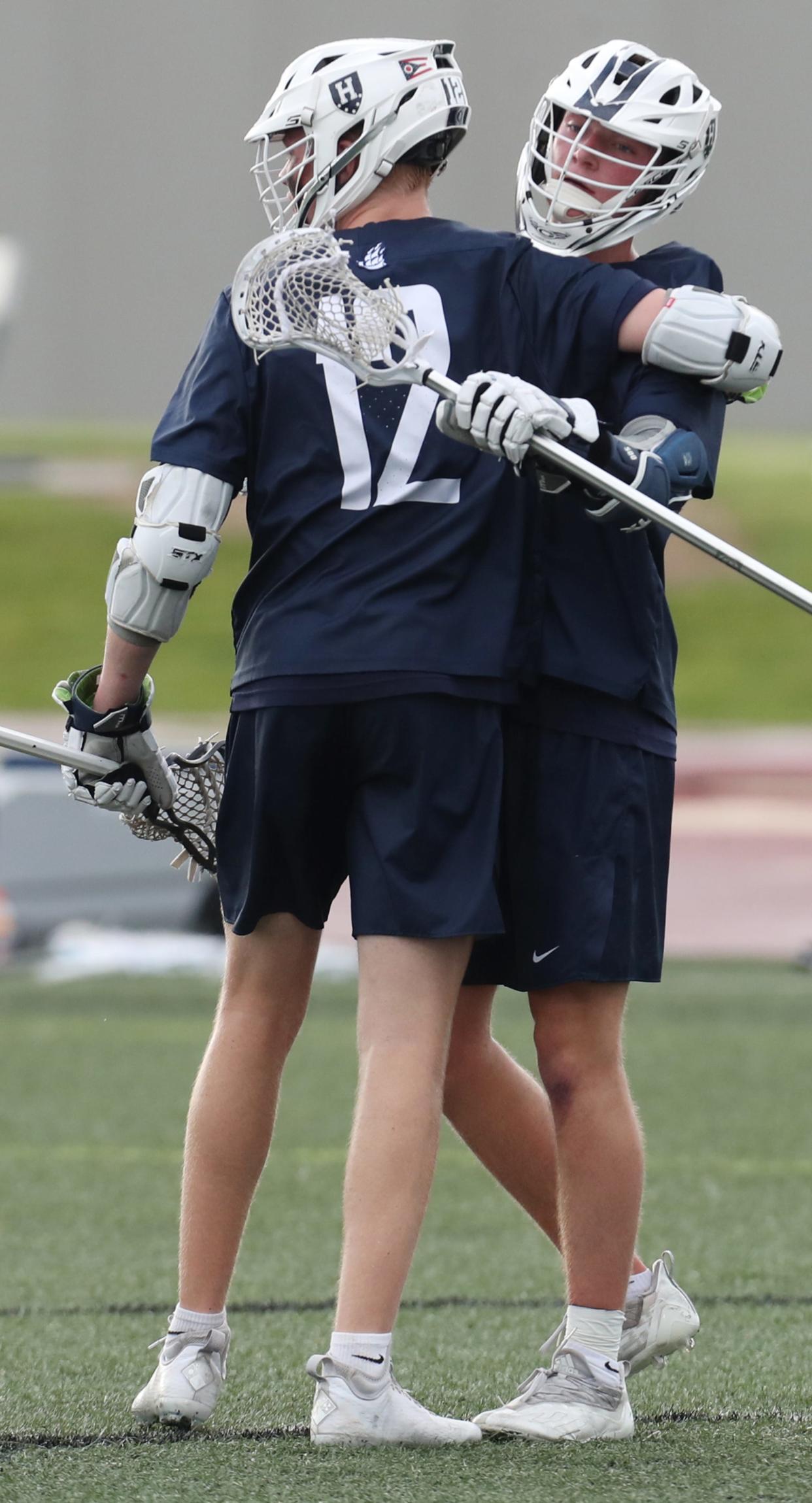 Hudson's Frank Mulvaney, 12, congratulates Jack Jenkins after Jenkins' score against Dublin Jerome in a Division I state semifinal lacrosse game at Ashland University's Ferguson Field in Ashland. Hudson lost 18-9.