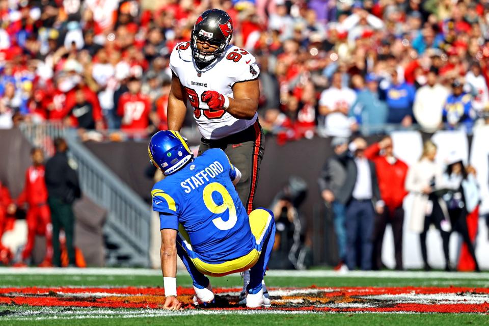 Bucs' Ndamukong Suh exchanges words with Rams' Matthew Stafford after a play in the first quarter Sunday.