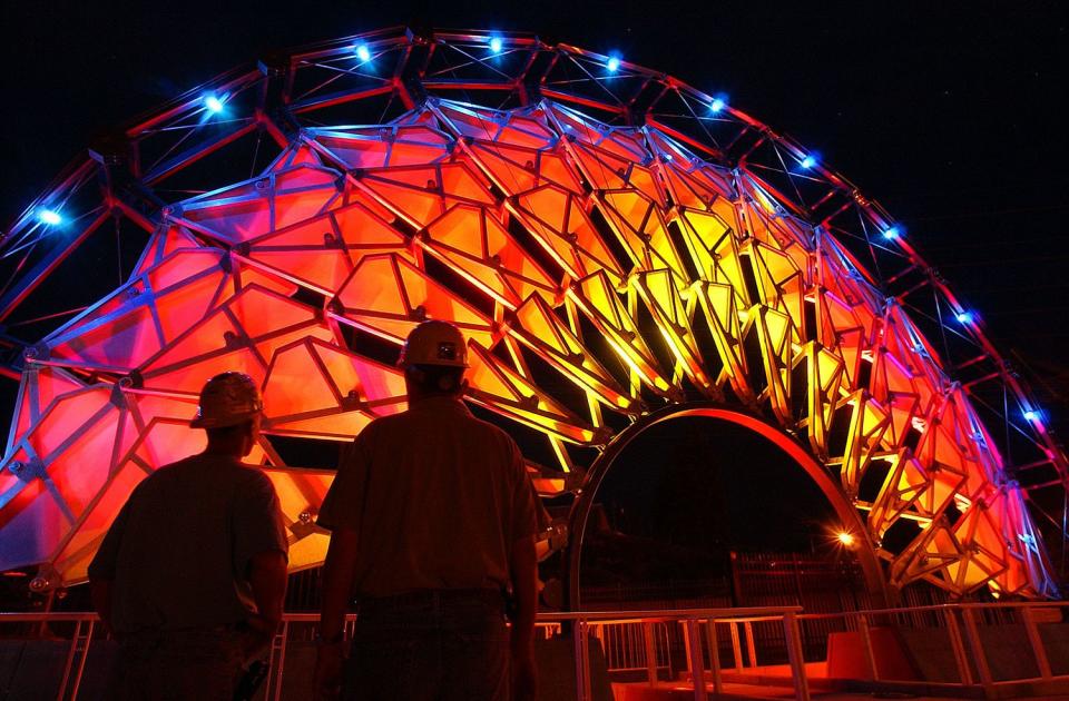 Jacobsen project manager Sean Tuite, right, and Scott Turnbow, project superintendent, test the lighting of the Hoberman Arch at the University of Utah on Aug. 20, 2003, in preparation for an Olympic Legacy Ceremony. The arch ended up outside of Rice-Eccles Stadium until it was moved in 2014.