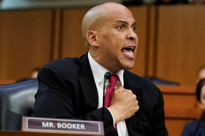 Senator Cory Booker holds a fist to his chest as he speaks at Ketanji Brown Jackson’s confirmation hearing.