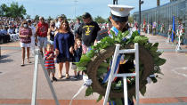 <p>As a wreath is placed for her husband Christopher Colafati, Marissa Coafati stands with her sons Xavier, 3, from left, and Damien, 6, and father-in-law Frank Colafati, Jr. during Jacksonville’s annual Memorial Day observance held at the Veterans Memorial Wall on Monday, May 29, 2017. The 65-foot-long monument and eternal flame serves as a tribute to almost 1,700 of Jacksonville’s fallen veterans. (Photo: Bruce Lipsky/The Florida Times-Union via AP) </p>