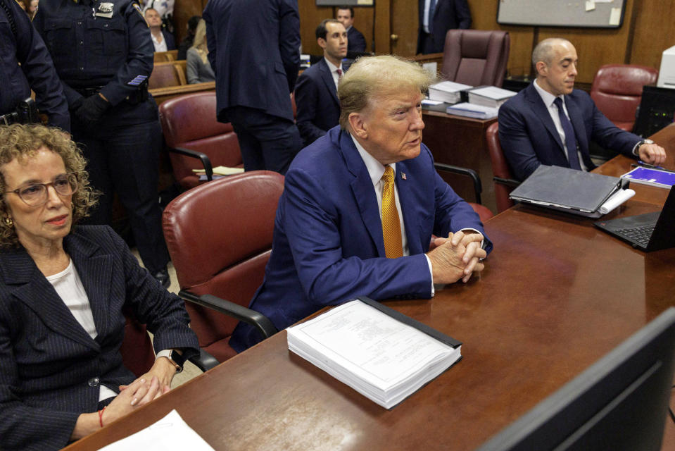 Former President Donald Trump, center, sits at the defense table with his attorneys Susan Necheles, left, and Emil Bove in Manhattan criminal court, Tuesday, May 7, 2024, in New York. (Sarah Yenesel/Pool Photo via AP)