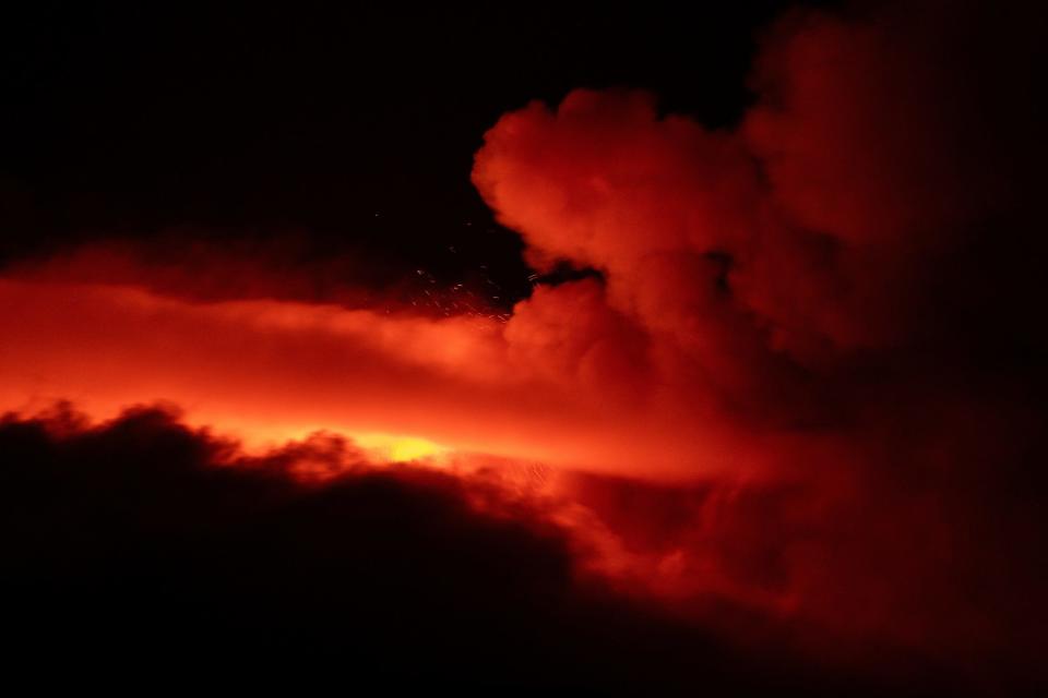 Plumes of smoke rise from Mount Etna.