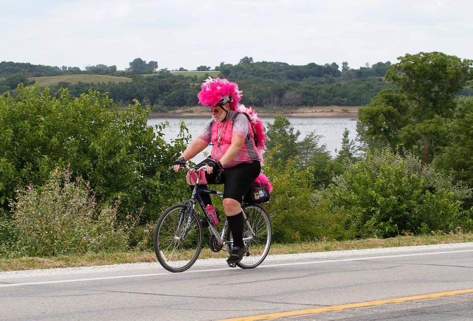 A pink-clad rider pushes up a hill on Highway 14 in Knoxville in 2013.