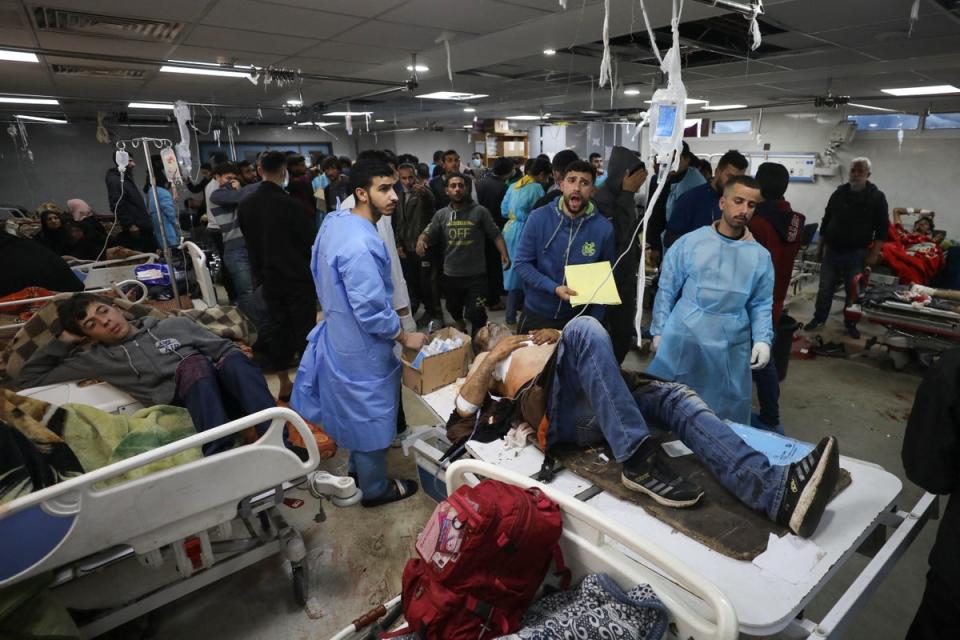 Injured Palestinians are brought to al-Shifa hospital in Gaza City following an Israeli airstrike on Sunday (AFP)