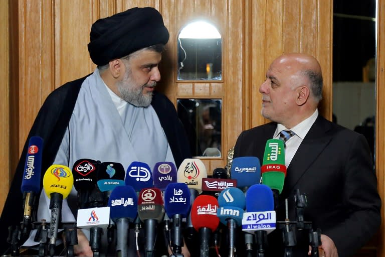 Iraqi Prime Minister Haider al-Abadi (R) is trying to hold on to his post by forming an alliance with popular Shiite cleric Moqtada Sadr, a former militia chief who demands greater political independence for Iraq from both Iran and the United States