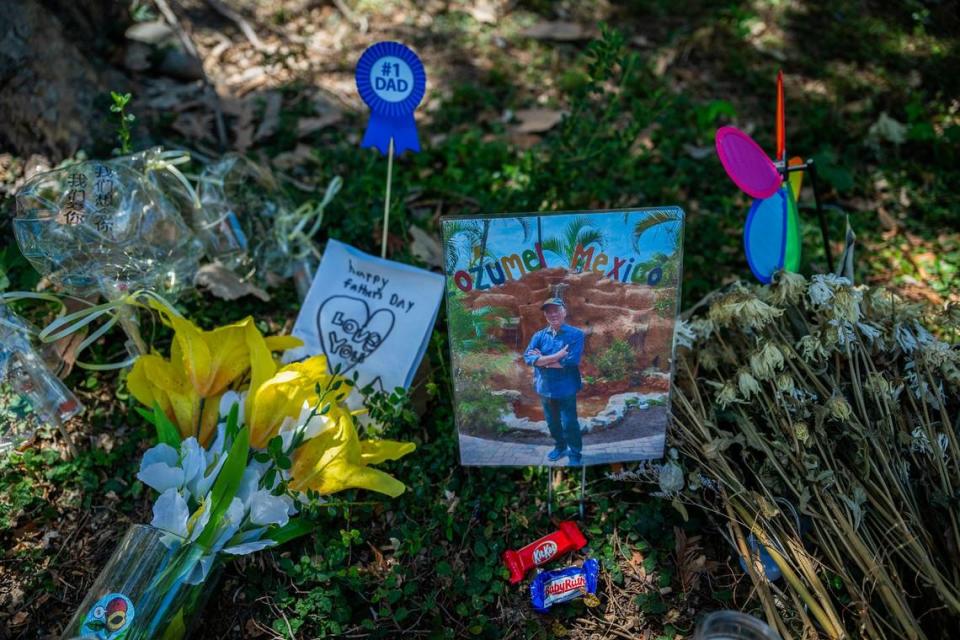 A memorial for Sau Voong, 84, rests along Club Center Drive near Banfield Drive earlier this month near the intersection where he was hit by a car June 11. It contains a Father’s Day card, flowers, and candy. 