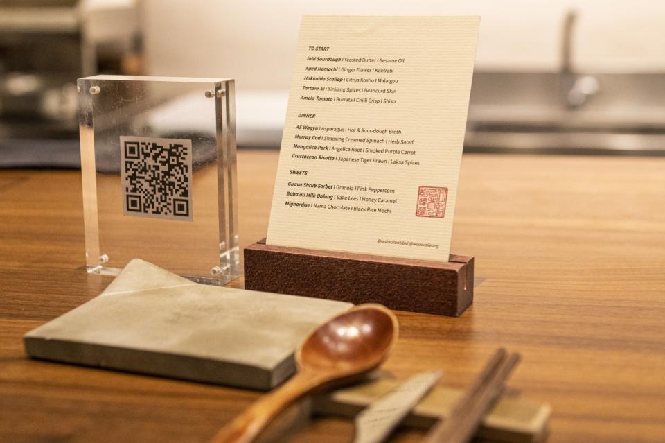 A paper menu for food, and a QR code for the drinks list at Restaurant Ibid.