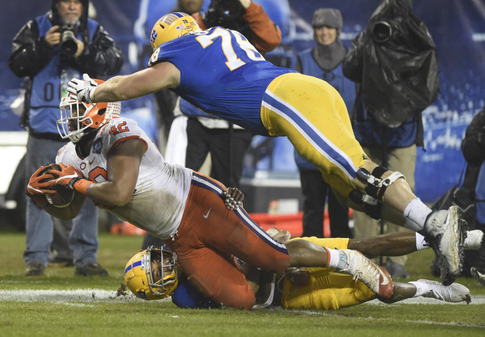 Clemson's Christian Wilkins (42) is tackled by Pittsburgh's Alex Bookser (78) after recovering a Pittsburgh fumble in the first half of the Atlantic Coast Conference championship NCAA college football game in Charlotte, N.C., Saturday, Dec. 1, 2018. (AP Photo/Mike McCarn)