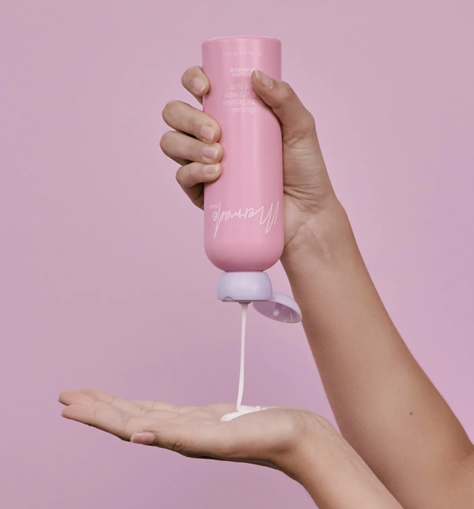 Mermade Hair styling shampoo being squeezed out onto an open palm