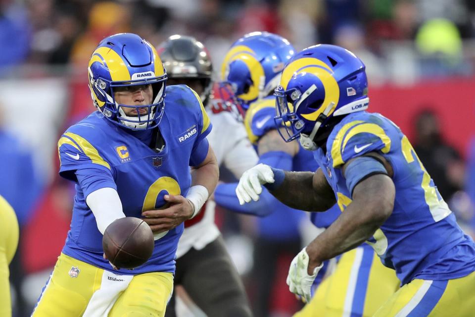 Rams quarterback Matthew Stafford hands the ball off to running back Cam Akers.