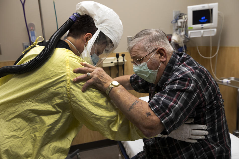 A healthcare worker helps Covid patient at a medical centre in North Dakota which has become awash with the virus. Source: Getty