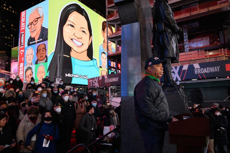 Mayor Eric Adams addresses attendees during a vigil held in honour of Michelle Go, whose image is displayed on a near by building, who was killed after being pushed onto subway tracks on January 15, in Times Square.