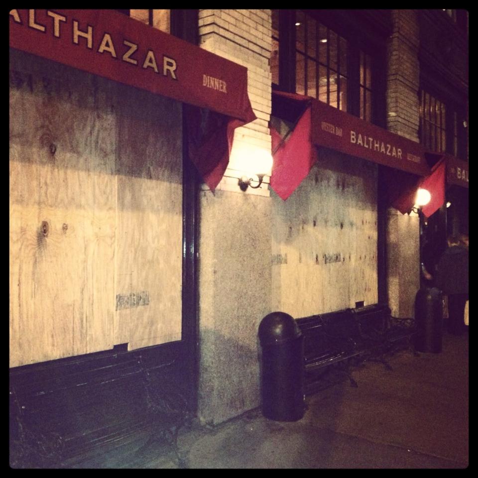 The windows of Balthazar, a popular restaurant in downtown Manhattan, are seen boarded up on Sunday, October 28, 2012. (David Hirschman)