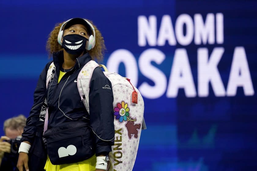 Naomi Osaka, of Japan, walks onto the court for her match against Marie Bouzkova, of the Czech Republic, during the first round of the US Open tennis championships, Monday, Aug. 30, 2021, in New York. (AP Photo/Elise Amendola)