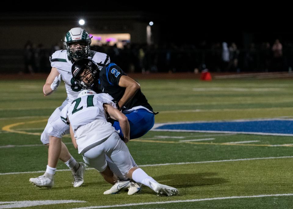 Pennridge defensive back Connor Lelii, front, and linebacker Tyler Wetzel, back, take down Central Bucks South wide receiver Tyler Robinson, on Friday, October 22, 2021, at Titans Stadium in Warrington. The Rams defeated the Titans, 35-10.