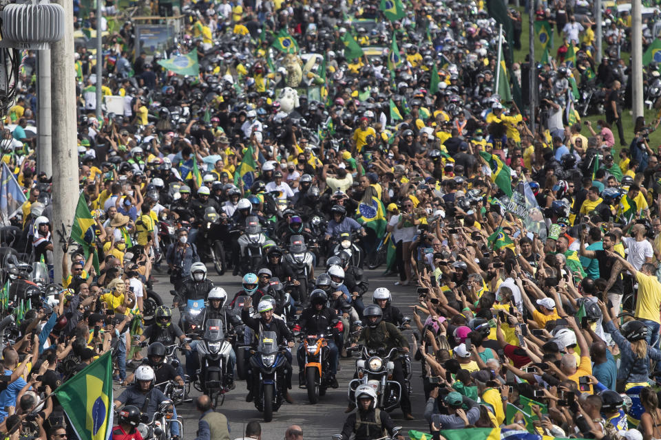 Brazil's President Jair Bolsoanro, center, takes a motorcycle tour with supporters in Rio de Janeiro, Brazil, Sunday, May 23, 2021. (AP Photo/Bruna Prado)