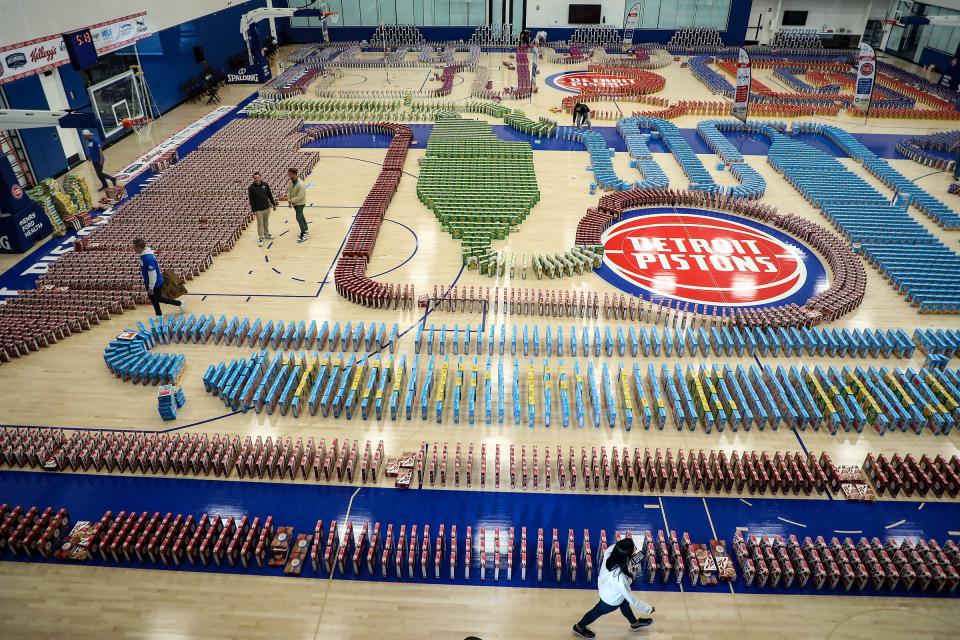 Move For Hunger attempts to break the Guinness world records for the most cereal boxes toppled in domino fashion at the Henry Ford Detroit Pistons performance center in Detroit on Thursday, Oct. 12, 2023. The previous record, set in 2021, stood at 6,391 boxes.