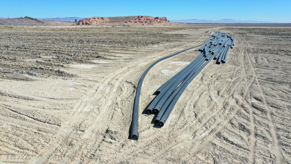 Large pipes sit in a pile at Red Hill Bay at the Salton Sea.  The pipes were part of a long running project to bring Alamo River water in to create a Red Hill Bay saline habitat for fish.  IID has bulldozed the project and created large furrowed trenches here to control the dust, November 3, 2021.