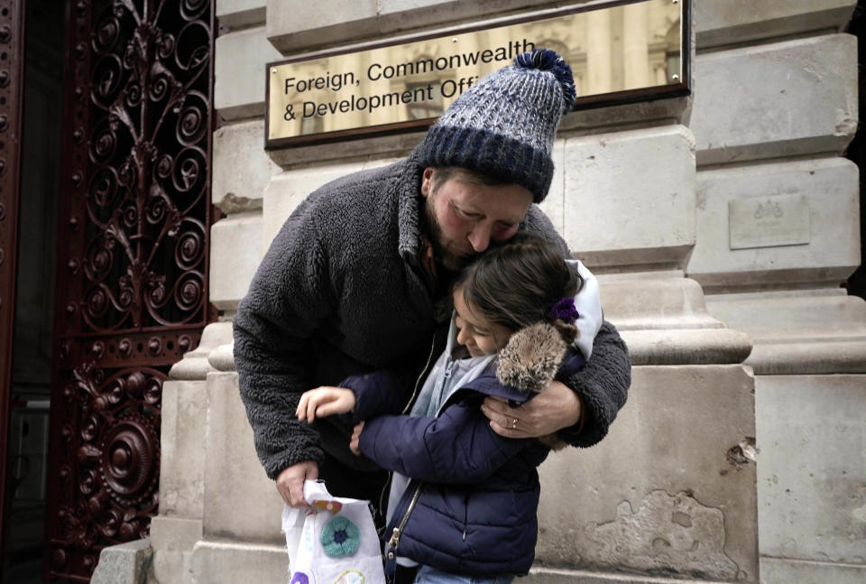 Richard Ratcliffe, the husband of Iranian detainee Nazanin Zaghari-Ratcliffe, with his daughter Gabriella, in London, Saturday, Nov. 13, 2021. The husband of a British-Iranian woman who has been detained for more than five years in Iran says he is ending his hunger strike outside Britain’s Foreign Office after 21 days. Ratcliffe has been sleeping in a tent outside the Foreign Office to pressure the British government to secure the release of his wife and other British-Iranian nationals. (Aaron Chown/PA via AP)