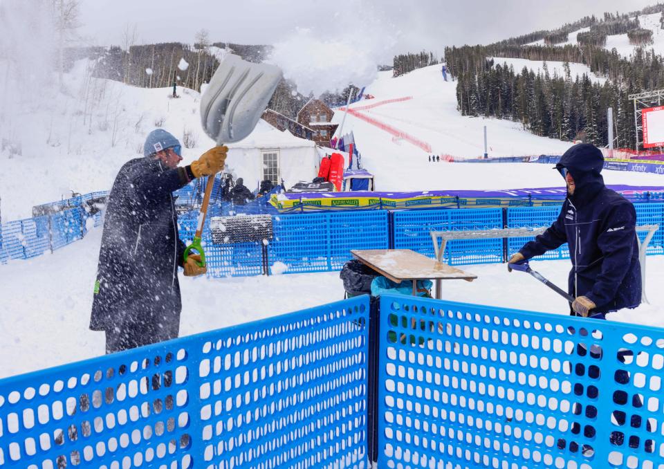 Course workers shovel snow out of the finish area in Avon, Colorado on Dec 2, 2023.