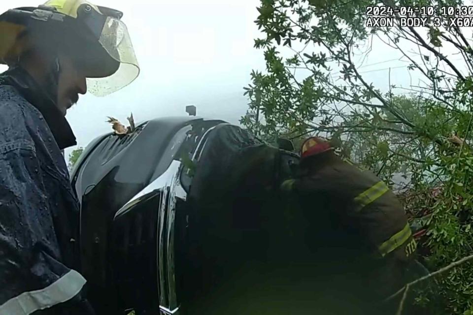 <p>Slidell Police Department/Facebook</p> Body camera footage from a Slidell police officer shows the moment a woman is rescued from her car after a tornado tore through town on April 10