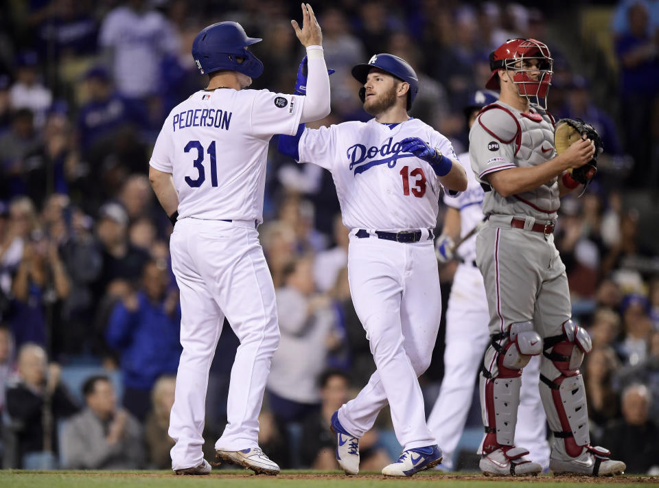 Los Angeles Dodgers' Max Muncy, center, is congratulated by Joc Pederson after hitting a two-run home run during the third inning of a baseball game against the Philadelphia Phillies Friday, May 31, 2019, in Los Angeles. (AP Photo/Mark J. Terrill)