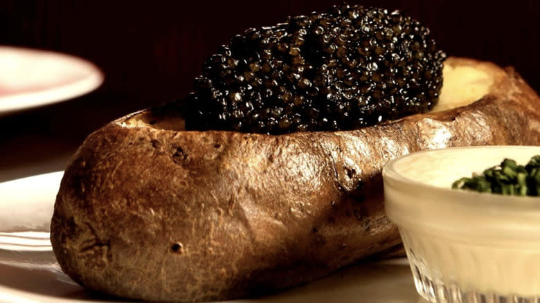 Closeup of baked potato topped with caviar 