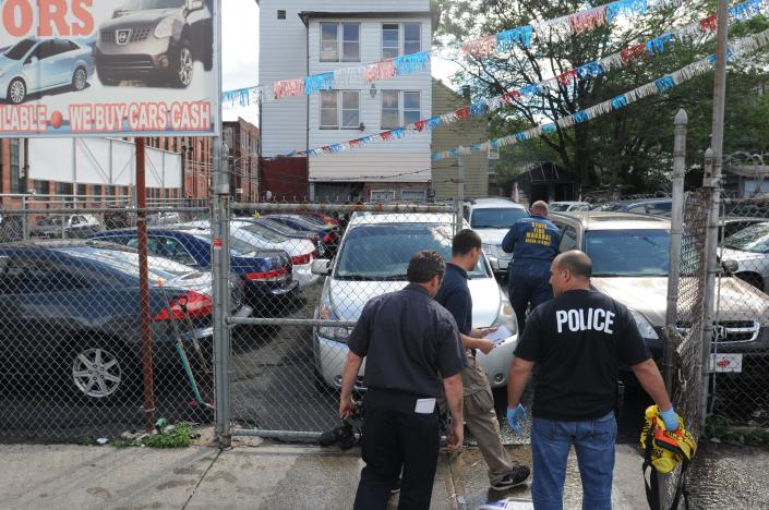 Several agencies, including AFT, State Fire Marshall,  investigate the scene of a fire at Hosanna Motors in Paterson in June 2014.