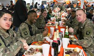 Soldiers at Bagram Airfield in Afghanistan enjoy Thanksgiving dinner in a file photo from 2018. While this year’s Thanksgiving meal may look different this year, the Defense Logistics Agency Troop Support has been providing traditional Thanksgiving food to field kitchens, dining facilities and galleys to locations in the United States and around the world. (Photo by SSG Caitlyn Byrne)