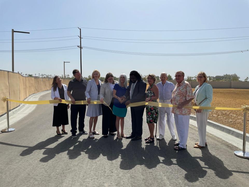 Laurie Skochil, the longest-serving current Betty Ford Center employee (35 years), and Dr. Olatunde Bosu, the newest employee (three weeks), middle, cut the gold ribbon to celebrate the Betty Ford Center's new entrance  in Rancho Mirage, Calif., on June 27, 2022.