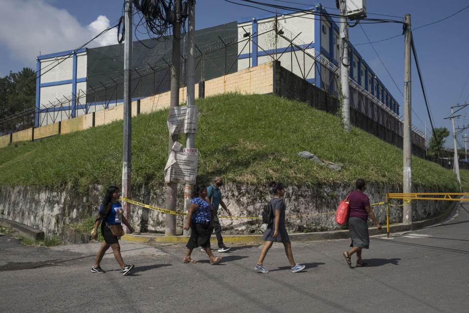 People arrive to the Mariona prison, a main penitentiary for men, to deliver food and personal items for their relatives who were arrested under the ongoing state of exception, on the outskirts of San Salvador, El Salvador, Wednesday, Oct. 12, 2022. (AP Photo/Moises Castillo)