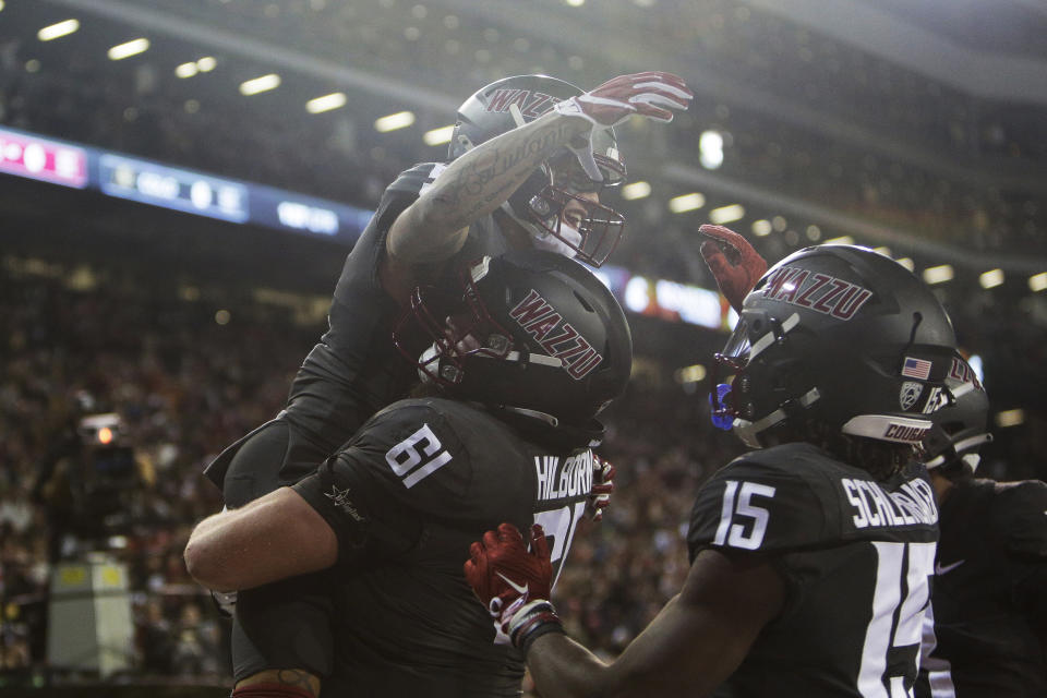 Washington State wide receiver Lincoln Victor (5) celebrates his touchdown against Colorado with offensive lineman Christian Hilborn (61) during the first half of an NCAA college football game Friday, Nov. 17, 2023, in Pullman, Wash. (AP Photo/Young Kwak)