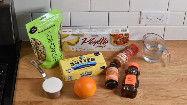 ingredients for orange pistachio baklava on wooden counter