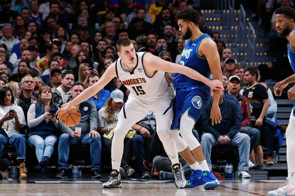 Nuggets C Nikola Jokic backs down Timberwolves C Karl-Anthony Towns.